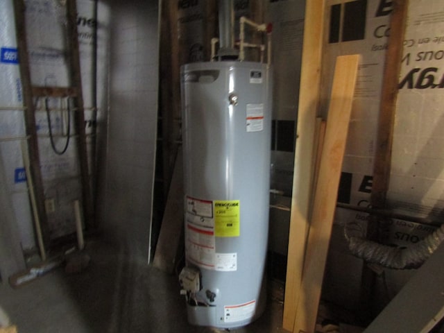 utility room featuring water heater