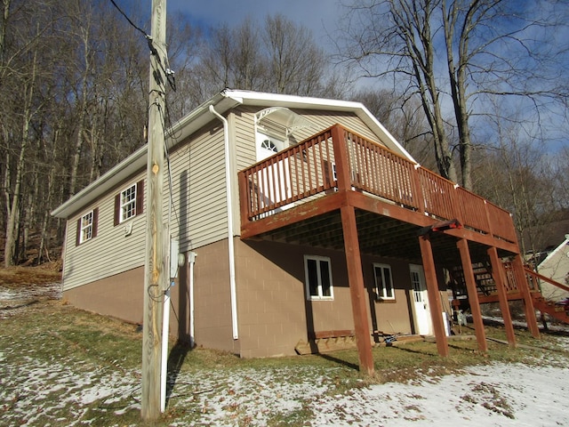 snow covered property featuring a wooden deck