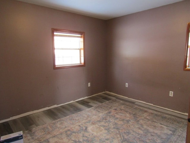 empty room with dark wood-type flooring