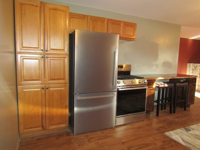 kitchen featuring stainless steel appliances and dark hardwood / wood-style floors