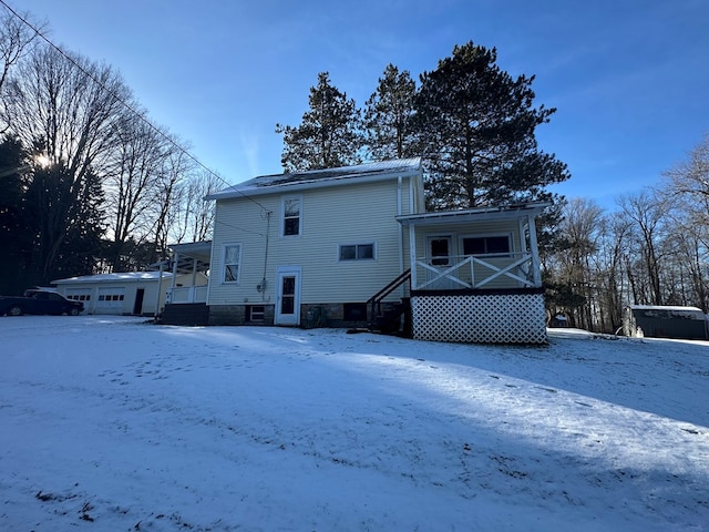 snow covered house with covered porch