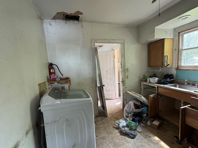207 William St, Towanda, PA 18848 - kitchen featuring washer / clothes dryer, brown cabinets, and a sink