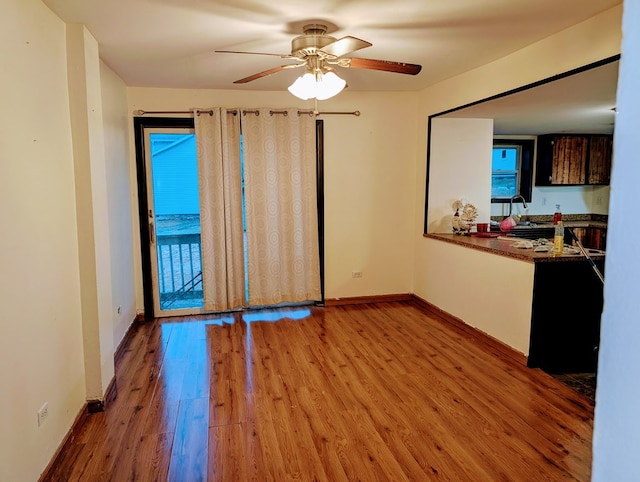 empty room featuring ceiling fan and light hardwood / wood-style flooring