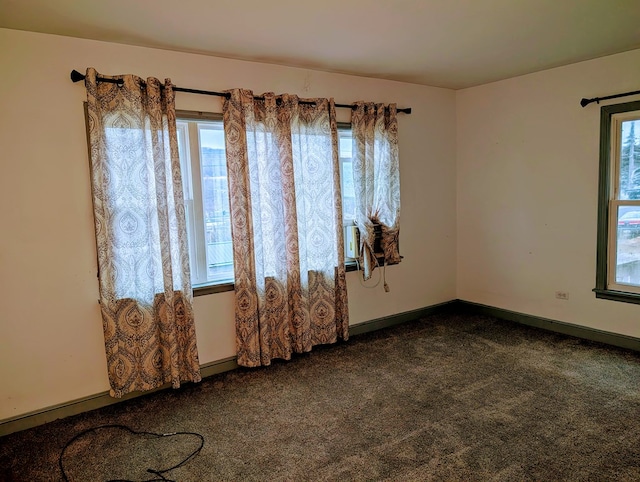 empty room featuring dark colored carpet