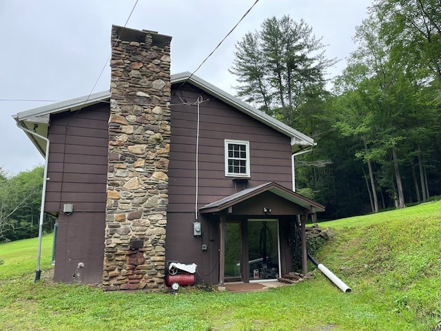 286 Hidden Hollow Farm Dr, Austin, PA 16720 - rear view of house featuring a chimney and a lawn