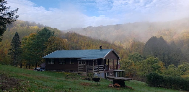 286 Hidden Hollow Farm Dr, Austin, PA 16720 - rear view of house featuring a forest view, a metal roof, and a yard