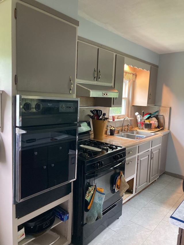 115 Pine St, Galeton, PA 16922 - kitchen featuring black appliances, under cabinet range hood, light tile patterned floors, light countertops, and gray cabinets
