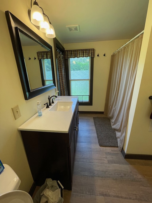 115 Pine St, Galeton, PA 16922 - full bath with wood finished floors, vanity, and a shower with shower curtain