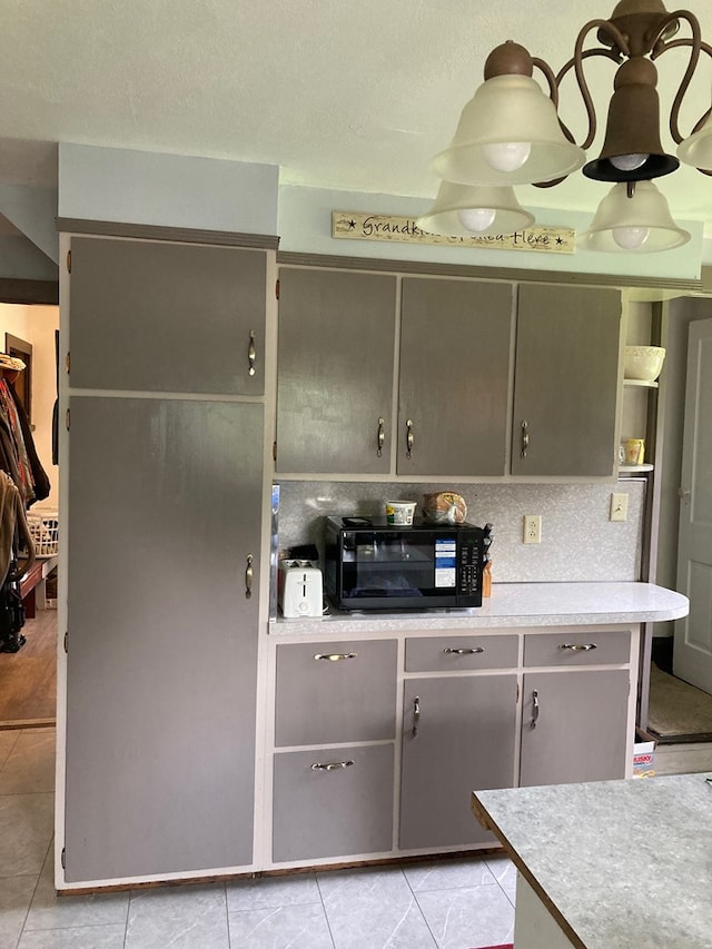 115 Pine St, Galeton, PA 16922 - kitchen featuring black microwave, light countertops, light tile patterned floors, and gray cabinets