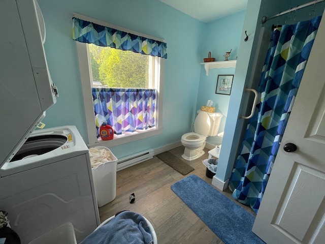115 Pine St, Galeton, PA 16922 - washroom featuring a baseboard heating unit, stacked washer / dryer, and wood finished floors