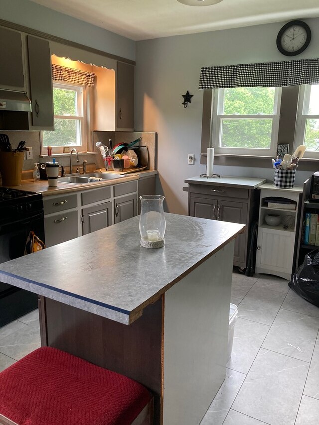 115 Pine St, Galeton, PA 16922 - kitchen featuring black range, under cabinet range hood, gray cabinetry, and light tile patterned floors