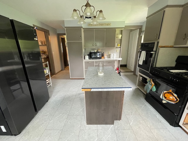 115 Pine St, Galeton, PA 16922 - kitchen with black appliances, open shelves, light countertops, a chandelier, and a center island