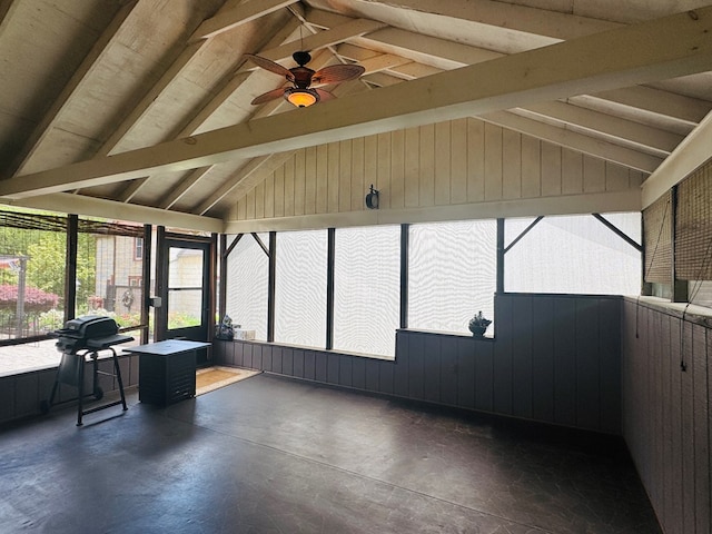unfurnished sunroom featuring a ceiling fan