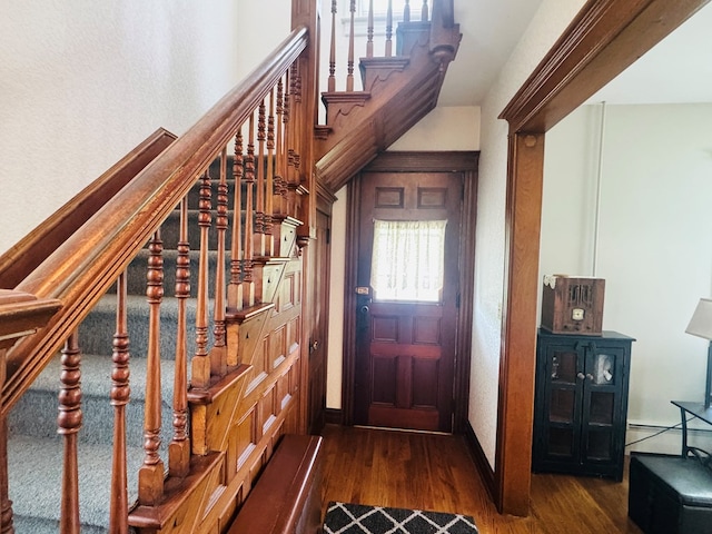 entryway featuring wood finished floors and stairway