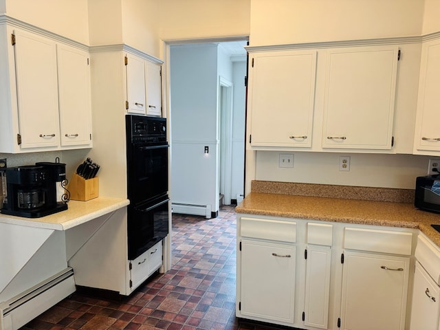 kitchen featuring baseboard heating, white cabinetry, black appliances, and light countertops