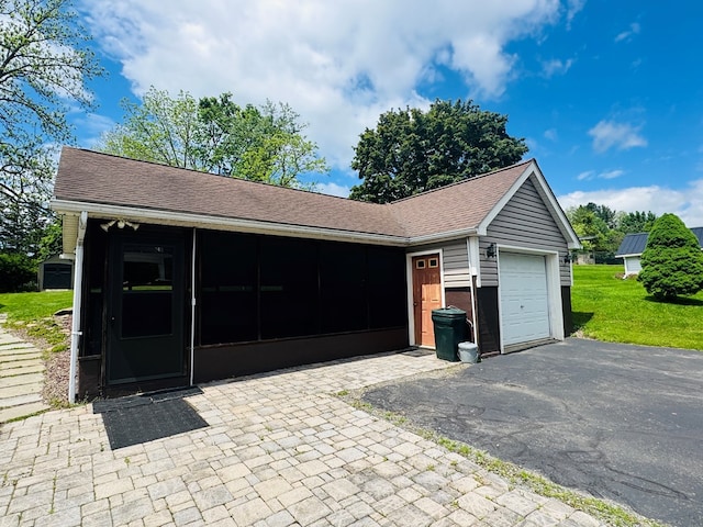 garage with asphalt driveway