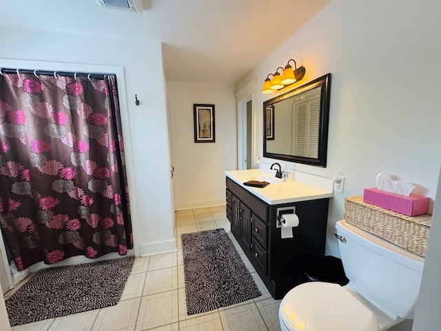 bathroom featuring toilet, vanity, and curtained shower