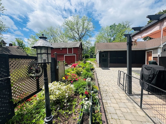view of patio with a sunroom and a grill