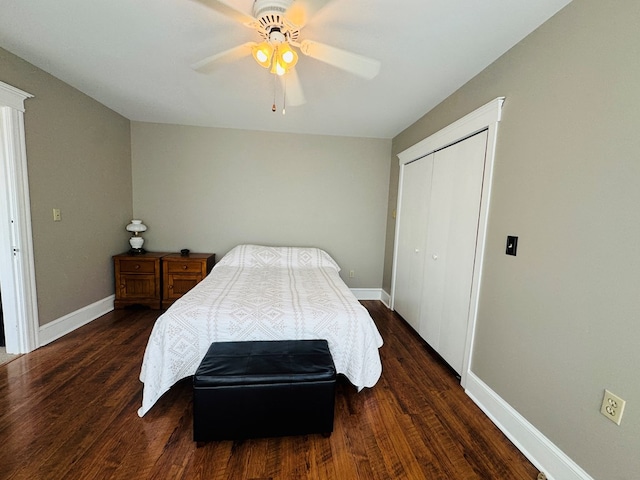 bedroom with dark wood-style floors, a closet, and baseboards