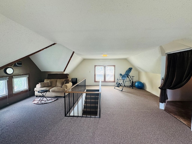 carpeted living area featuring a textured ceiling and vaulted ceiling