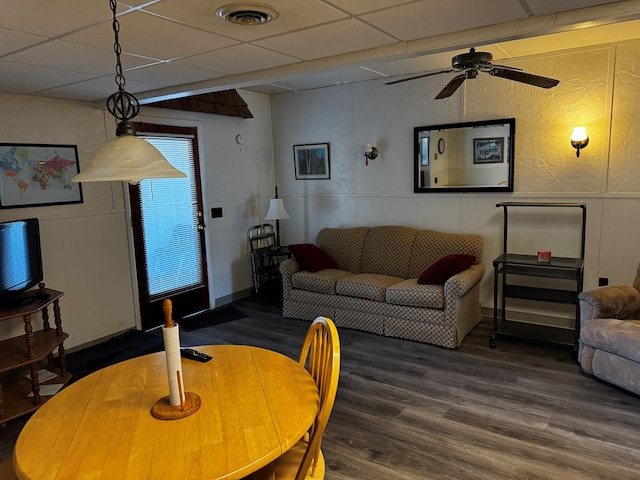 living room with hardwood / wood-style flooring and a paneled ceiling