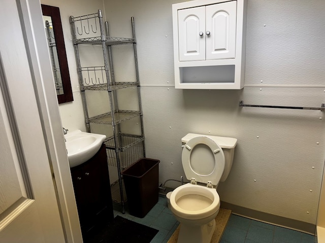 bathroom with vanity, tile patterned floors, and toilet