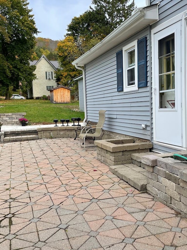 view of patio featuring a storage shed