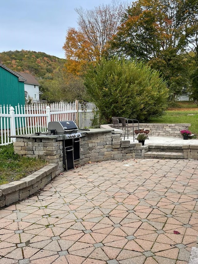 view of patio / terrace featuring a mountain view and exterior kitchen