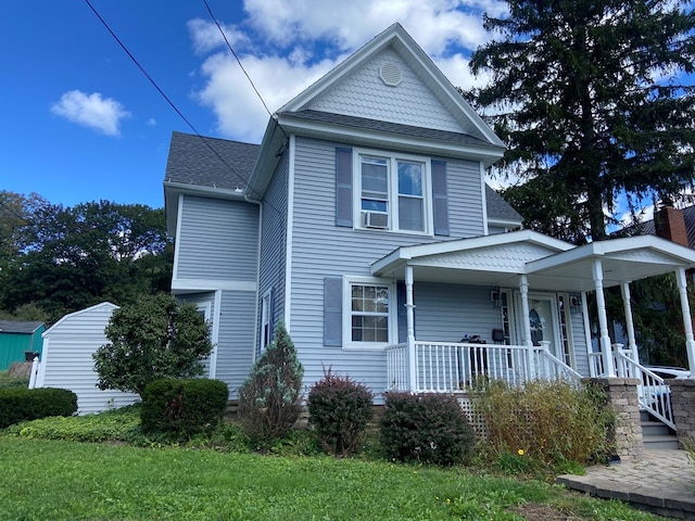 view of front facade with cooling unit and covered porch