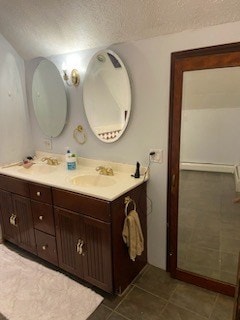 bathroom with vanity and a textured ceiling