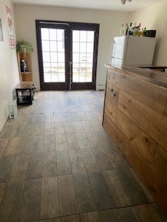 interior space with ceiling fan and french doors