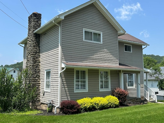 408 S E St, Coudersport, PA 16915 - view of side of home featuring a chimney and a yard