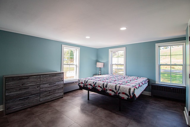 bedroom featuring radiator heating unit and crown molding