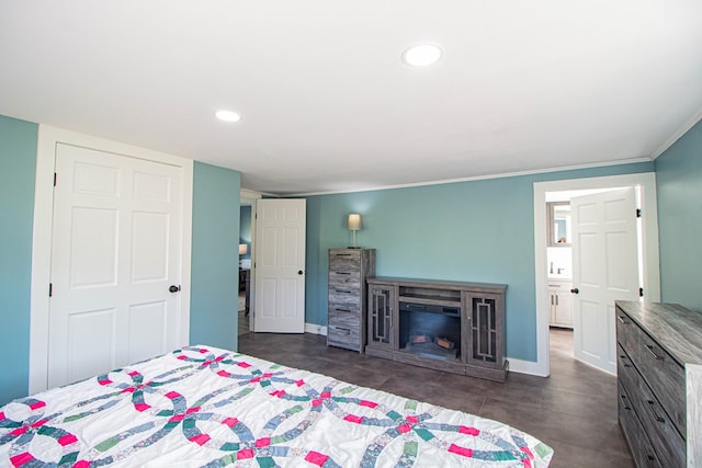 bedroom with ensuite bath and ornamental molding