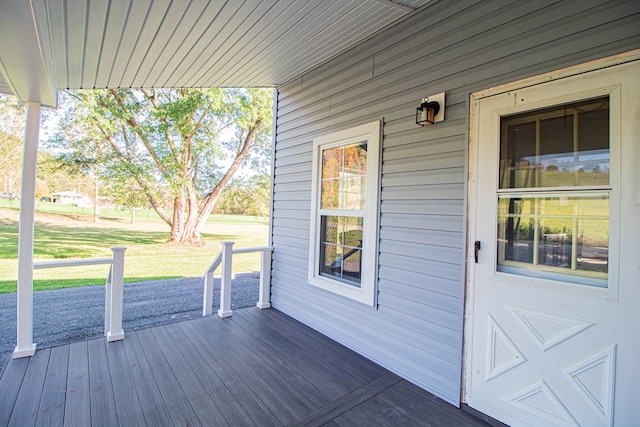 wooden deck featuring a yard and a porch