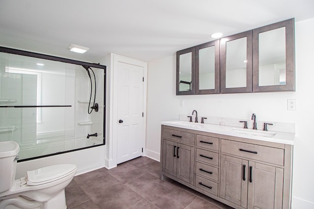 full bathroom with vanity, toilet, and bath / shower combo with glass door