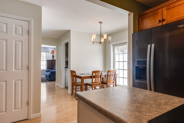 6270 Wolf Run Rd, Campbell-Savona, NY 14821 - kitchen with refrigerator with ice dispenser, dark countertops, light wood-type flooring, and brown cabinets