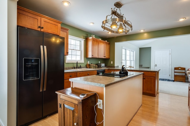 6270 Wolf Run Rd, Campbell-Savona, NY 14821 - kitchen with black appliances, a peninsula, a sink, a kitchen island, and light wood-type flooring