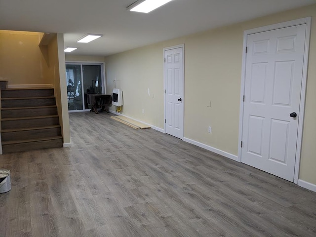 basement featuring heating unit and light wood-type flooring