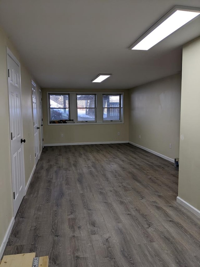 unfurnished room featuring dark hardwood / wood-style flooring