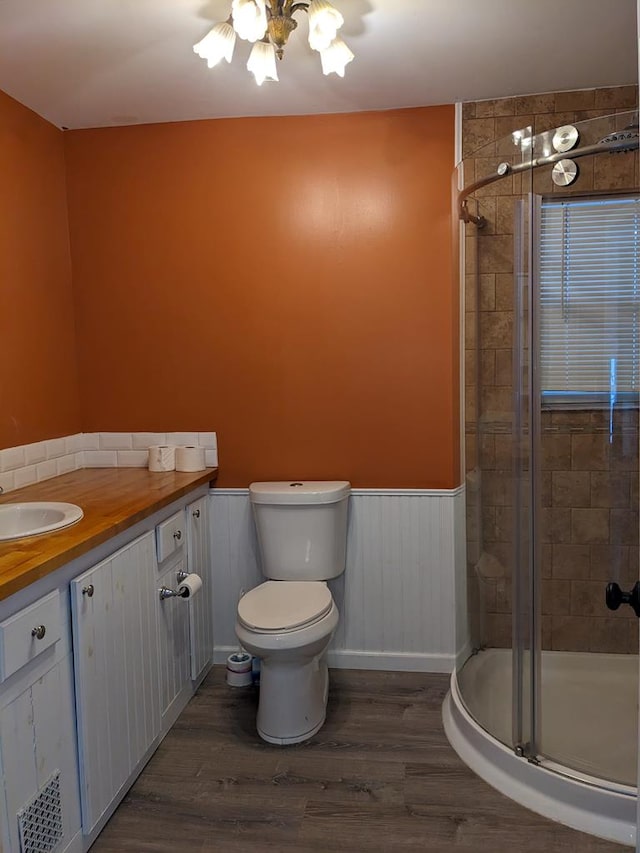 bathroom with vanity, an enclosed shower, hardwood / wood-style flooring, and toilet