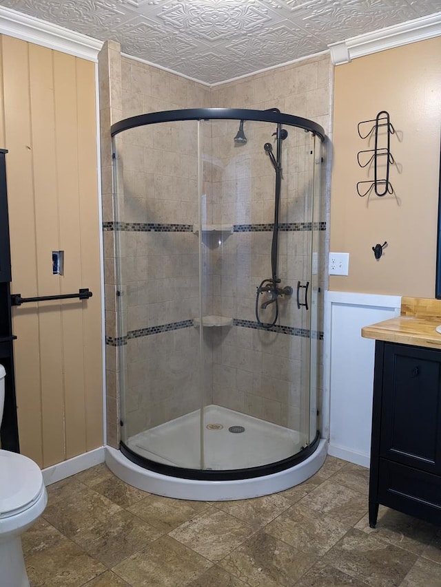 bathroom featuring vanity, a shower with door, and toilet