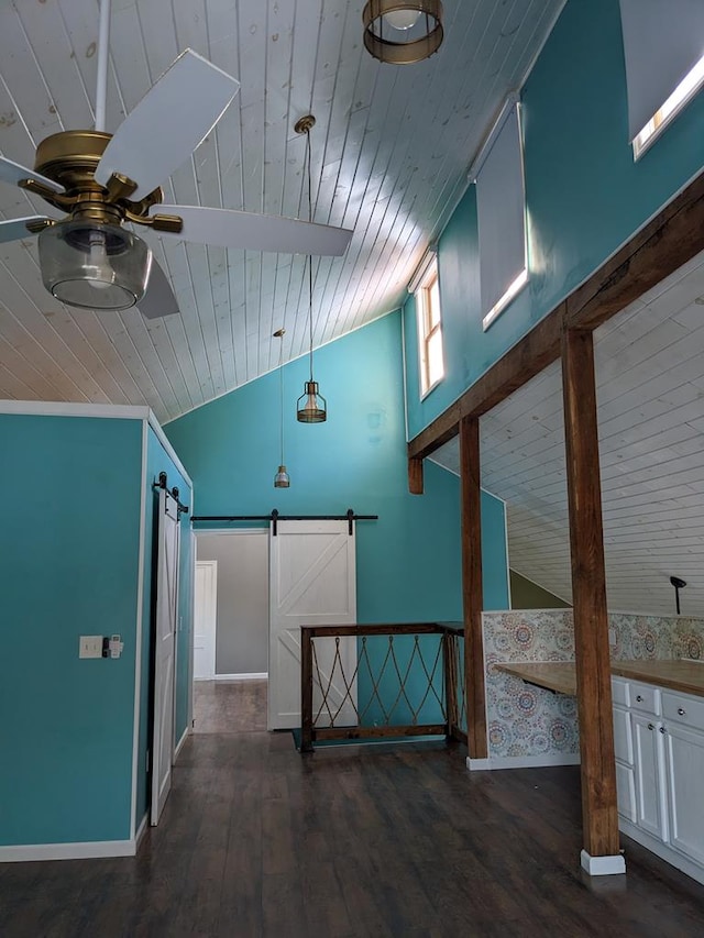 hall featuring vaulted ceiling, a barn door, dark wood-type flooring, and wooden ceiling