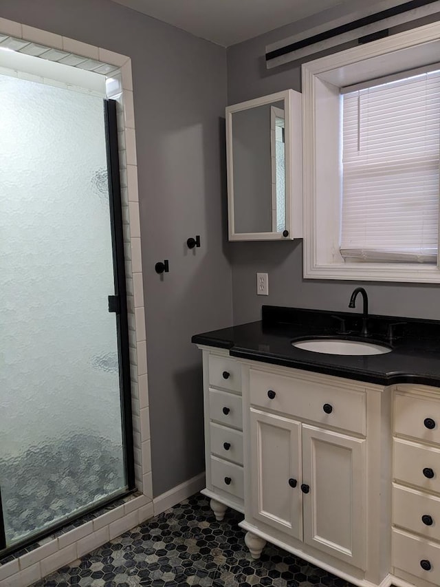 bathroom featuring vanity and a tile shower