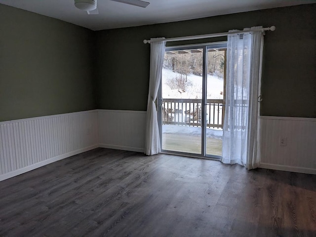 spare room featuring dark hardwood / wood-style floors and ceiling fan