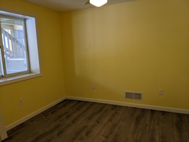 spare room featuring dark wood-type flooring