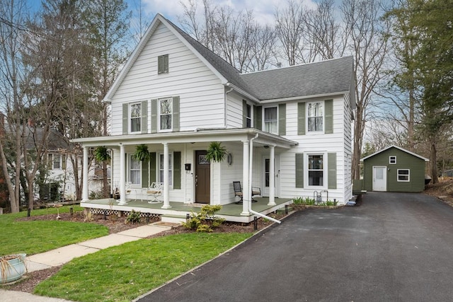 13 King St, Wellsboro, PA 16901 - view of front of property featuring a porch, a shingled roof, an outdoor structure, driveway, and a front lawn