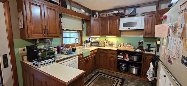 1972 Burnham Rd, Gillett, PA 16925 - kitchen with white appliances, a sink, light countertops, brown cabinets, and a textured ceiling