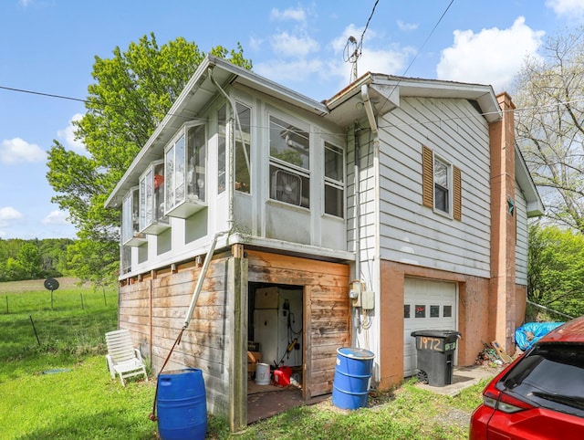 1972 Burnham Rd, Gillett, PA 16925 - back of property featuring a garage, a sunroom, and a chimney