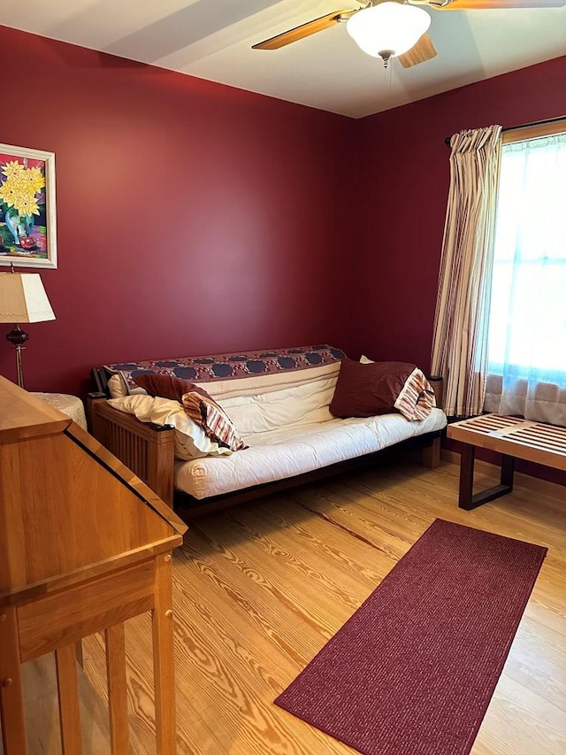 living area featuring hardwood / wood-style flooring and ceiling fan